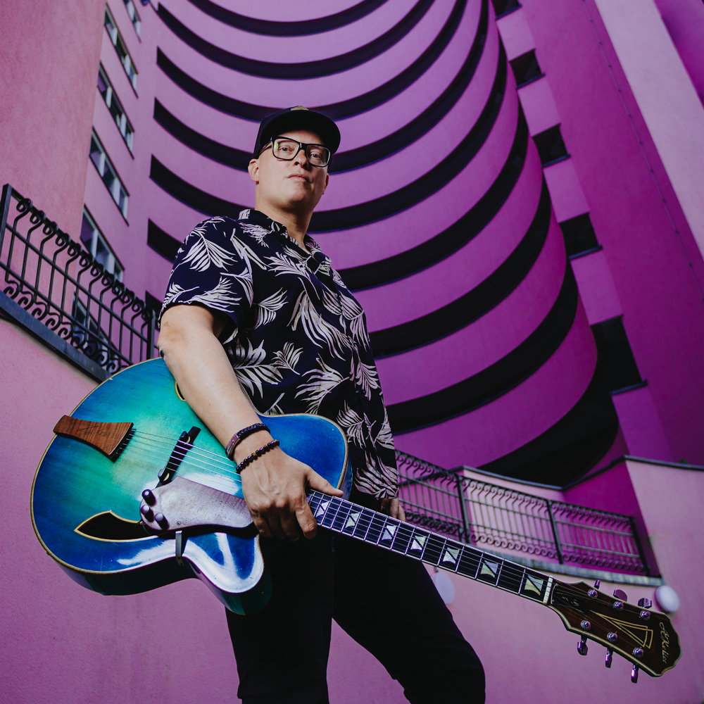 Picture of musician Torsten Goods holding his guitar.